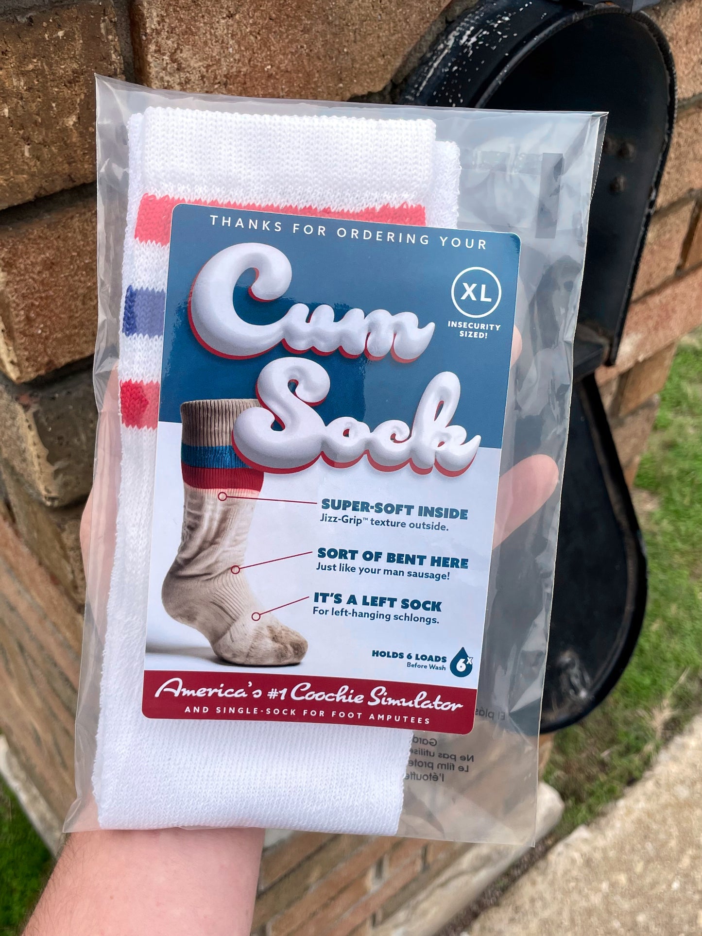 Point of view of the recipient retrieving the Cum Sock prank package from their mailbox.